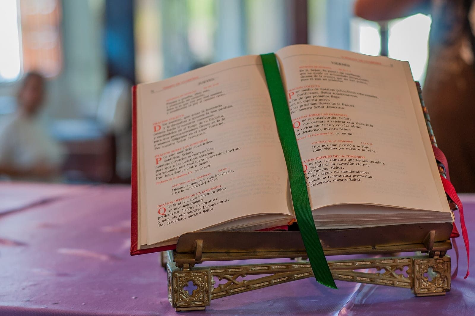 An open Bible resting on a lectern inside a church